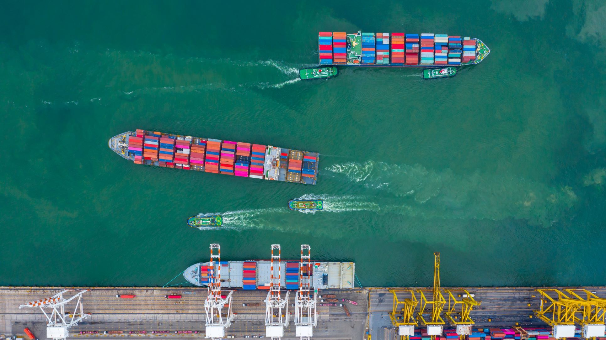Aerial view cargo ship terminal Unloading crane of cargo ship terminal Aerial view industrial port with containers and container ship 1166335171 5350x3006 2
